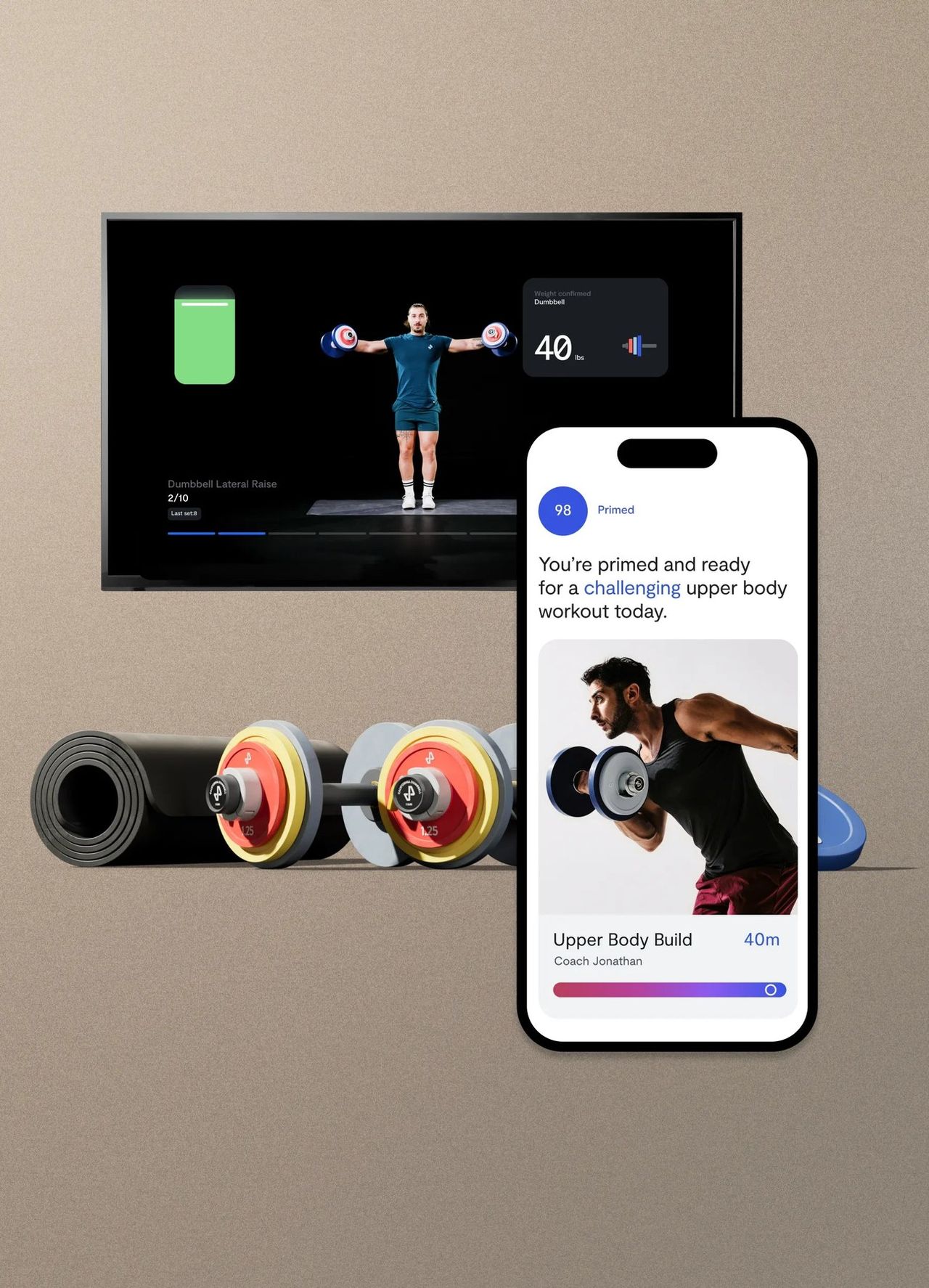A TV showing a Tempo class, an iPhone with today’s session, a rolled mat and two dumbbells with colour-coded plates.